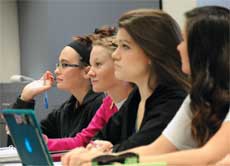students listen to their professor during a College of Education class