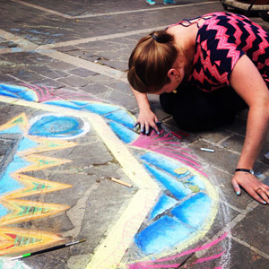 Student working on sidewalk chalk art