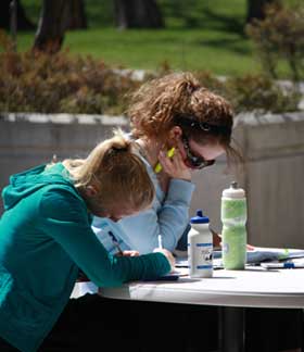 two students studying outdoors on the MSUB university campus