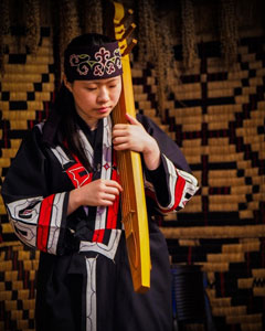 Ainu woman with traditional instrument