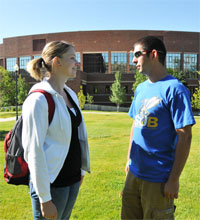 two students talking in front of the College of Education building on the main MSUB campus