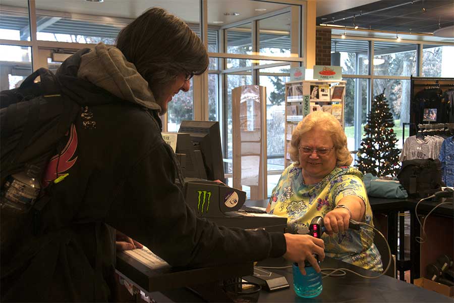 Terri helping a student at the campus store