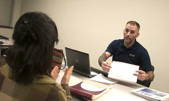 MSUB student Scott Gorman helps a person with her taxes