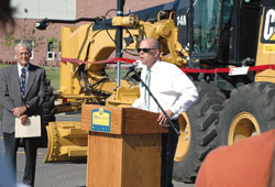 Dean Cech accepts the gift of heavy equipment from 