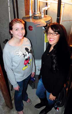 students stand next to new water heater