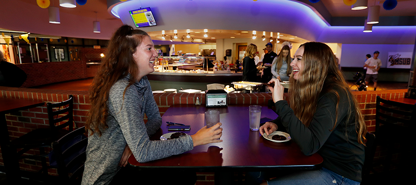 Students meeting in the dining hall.