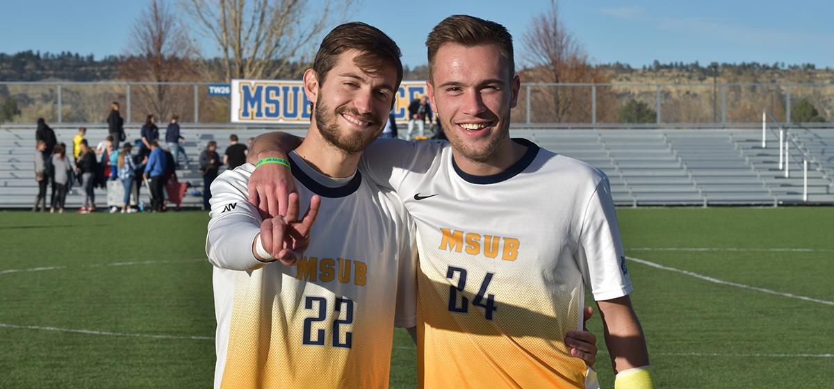 Two MSUB Soccer Mens Soccer players on a soccer field
