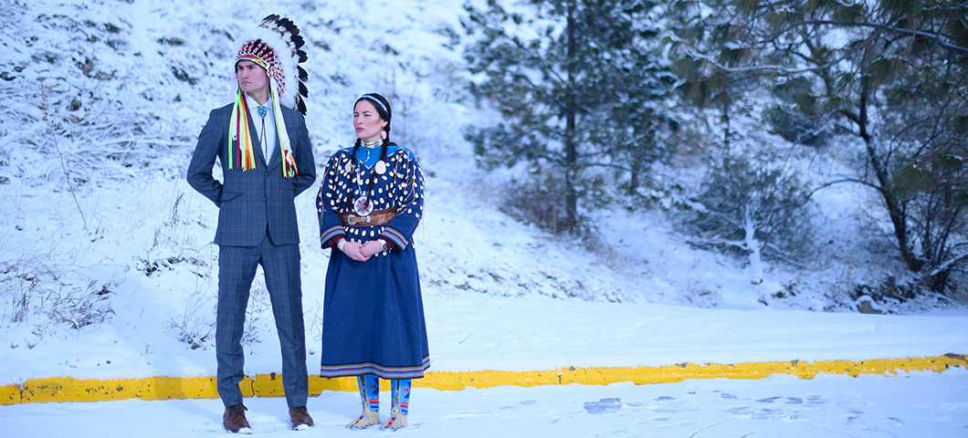 Native American woman and man standing in the snow