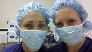Two students getting ready to observe a surgical procedure