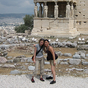 Student posing in front of ancient structure