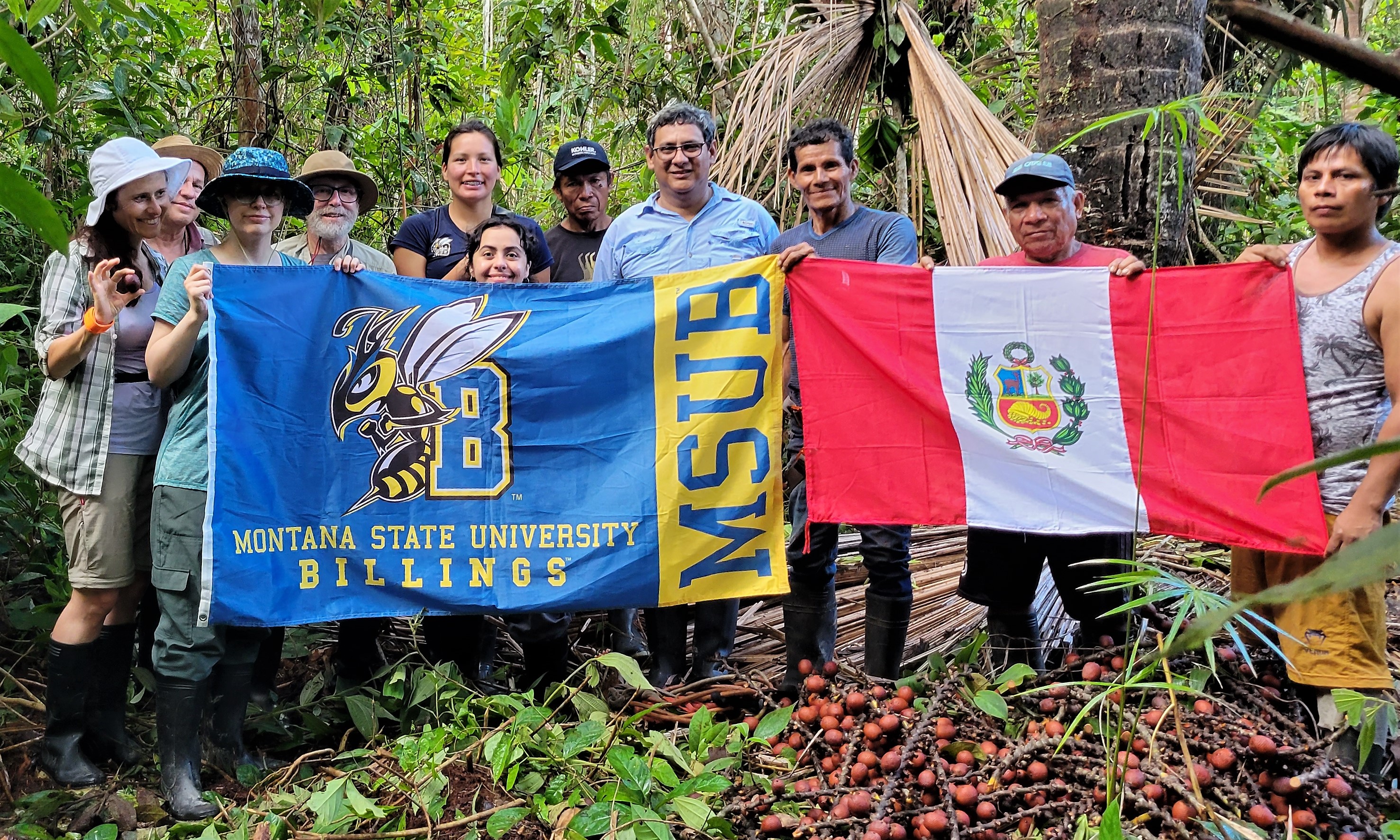 Group of people in the jungle holding flags