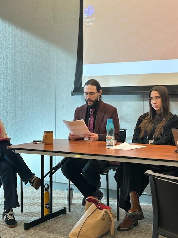 student presenting paper at conference