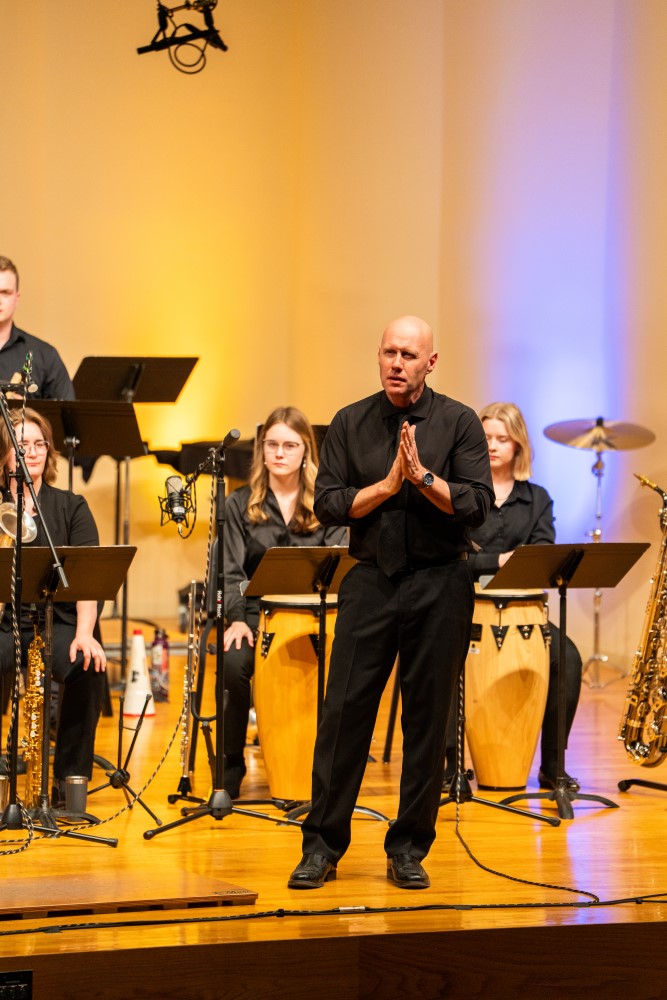 John Roberts speaking at concert