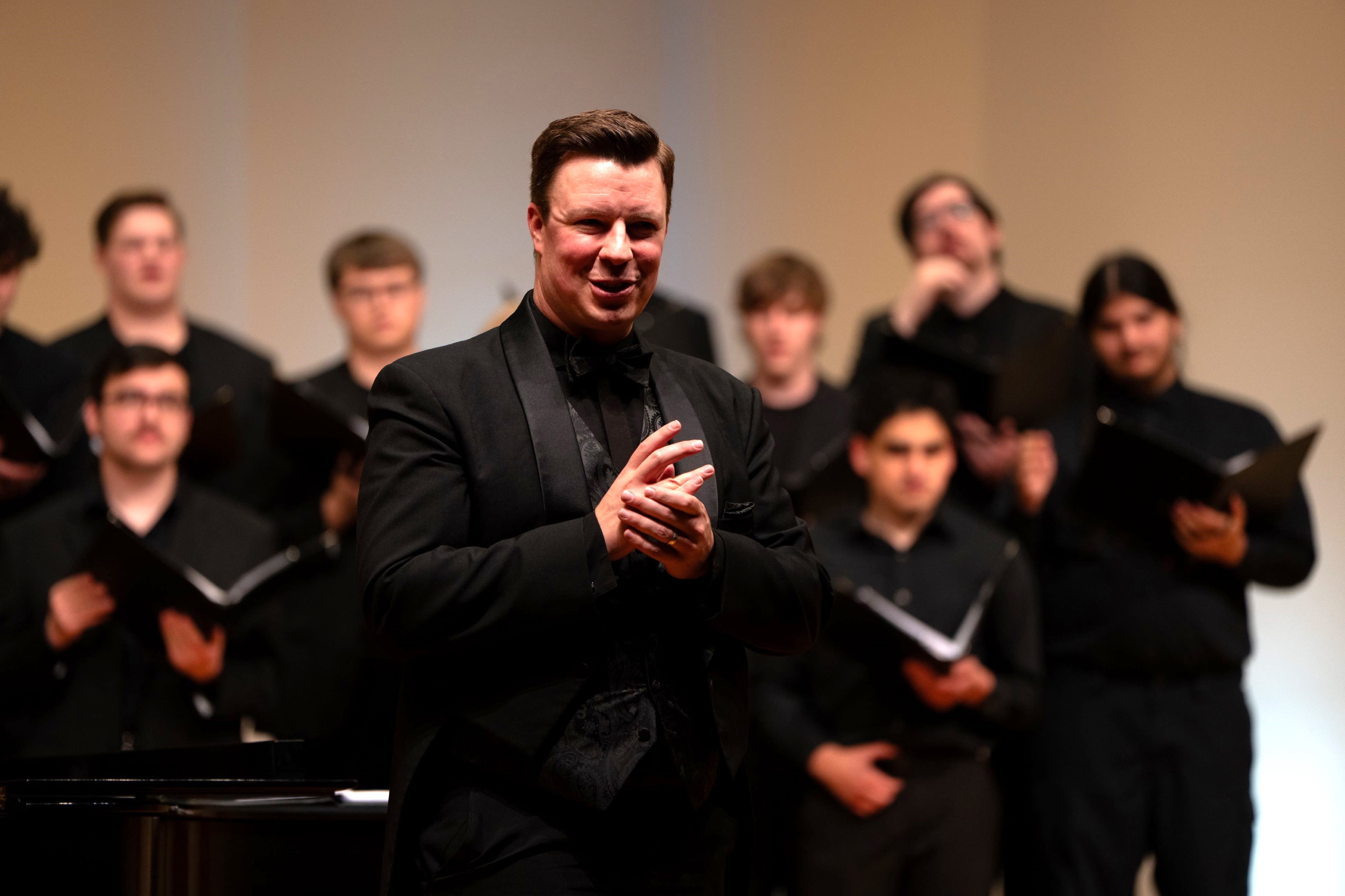 Daren Small speaking to audience at choir concert