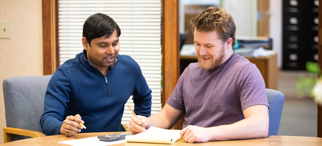 finance instructor working with student