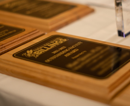 wooden plaque with black and gold facing