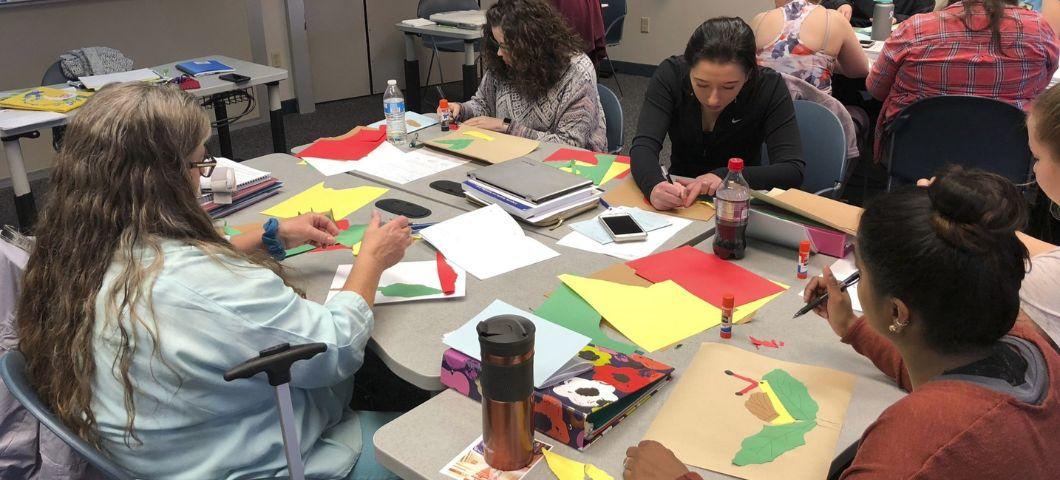 Students sit at a table and work together during class