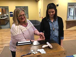 Two women getting fingerprints taken