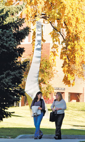 two students walking through the main MSUB campus in autumn