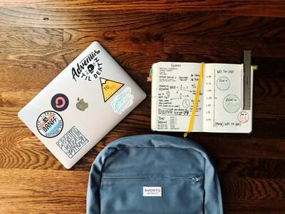 laptop, notepad and backpack