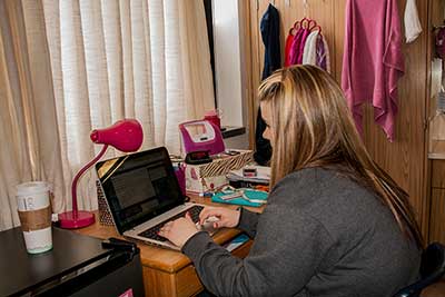 a student studying in her residence hall room