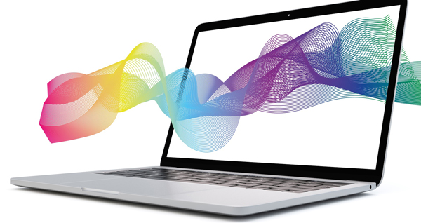 a rainbow colored design floating into a laptop screen