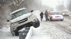 vehicle on top of guardrail along snowy road