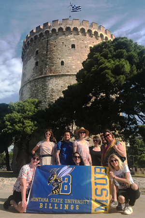 MSUB student group in Greece with MSUB flag