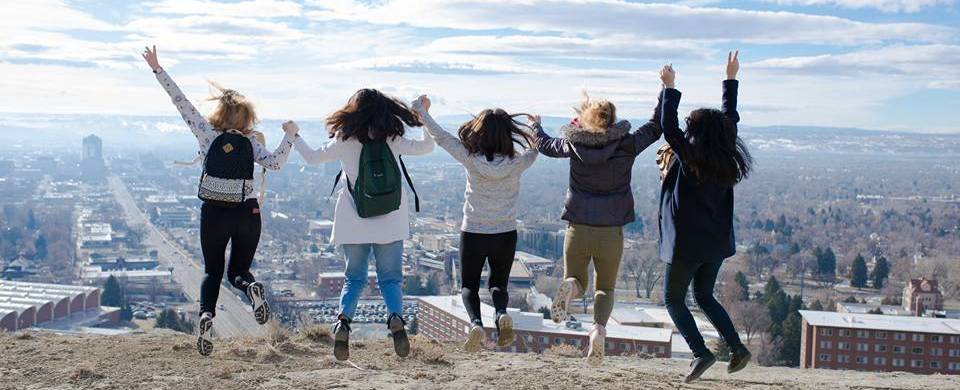 International students jumping on the Rims above MSUB campus