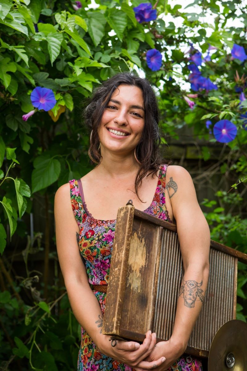 "Dizzy" Incirlioglu, percussionist, holding washboard