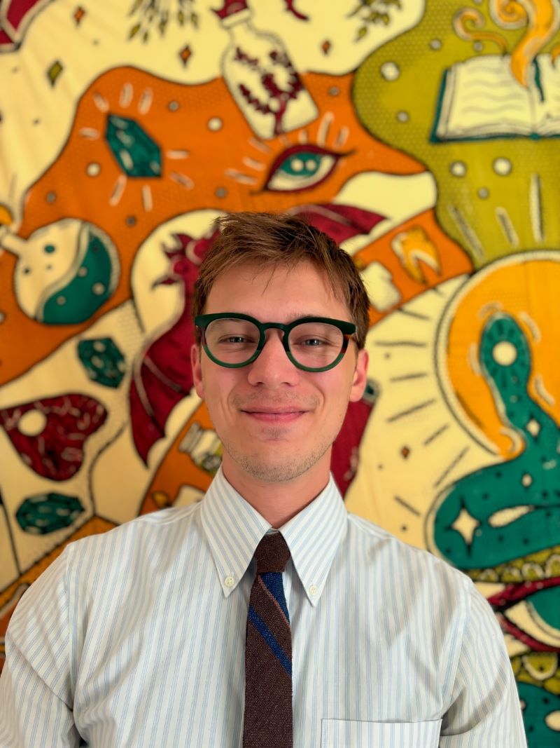 Stephan Tenney headshot in front of colorful wall