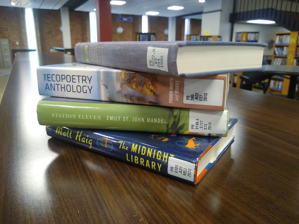 A pile of colorful books on a table.