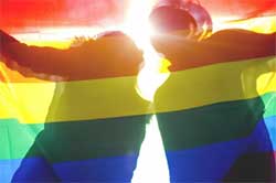 a rainbow flag held by two people