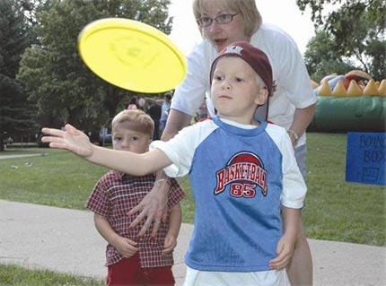 MSUB staff member Debbie Brown helps happy children at Summerfair 2007
