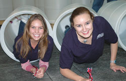 Grace and Ashley inside the recycling barrels