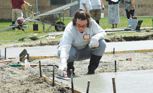 a women's prison inmate works on sidewalk contstruction