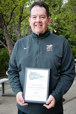 Coach Kevin Woodin holding his award.