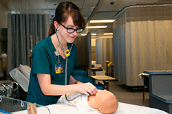Dustin Kelly prepares for her final examination in City College’s nursing lab