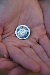 Dustin Kelly holds her MSU Billings nursing pin