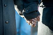 observers hold hands during the bellringing ceremony