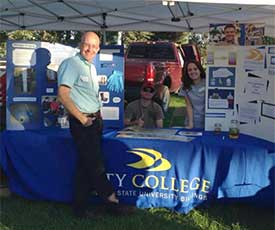 Andrew Sullivan, left, poses with City College students at the recent Phillips 66 Meet in the Park