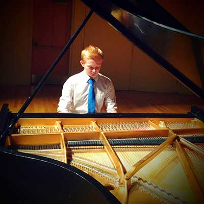 Benjamin Roberts playing a piano