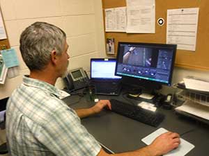 Outdoor Adventure Leadership Assistant Professor Clinton Culp observes video provided by cameras mounted onto eye-tracking glasses