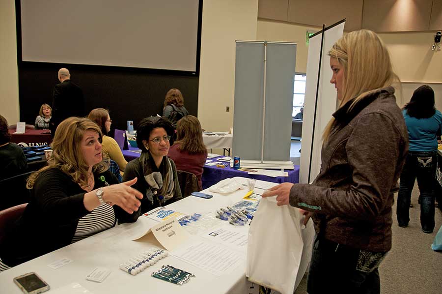 a student talks to employers at the Career Fair