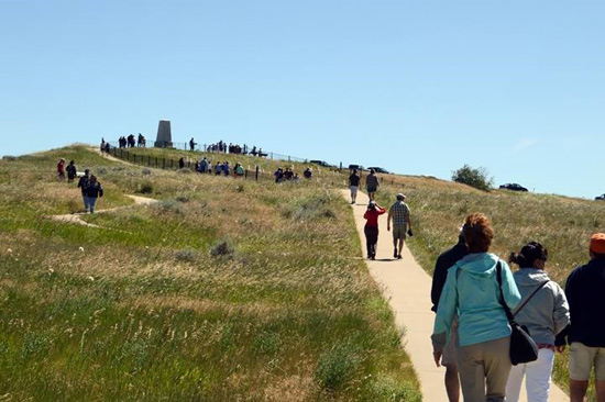 During the 140th anniversary celebrations visitors walk up the path to Last Stand Hill. Credit: NPS