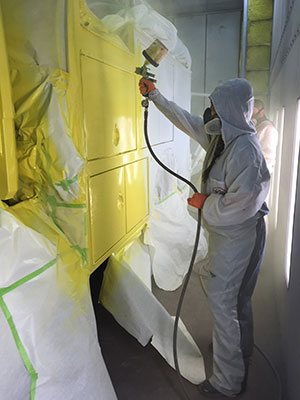 a City College students paints the fire truck