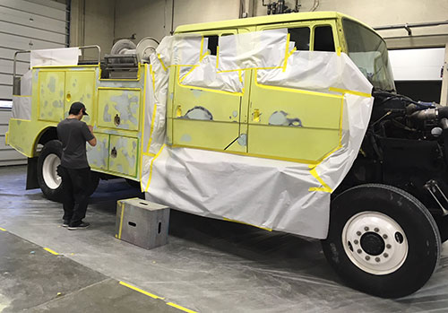 a City College students paints the fire truck