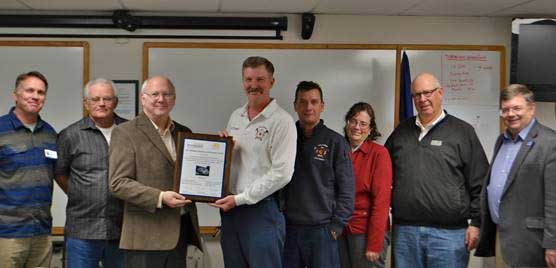 Chancellor Larsen presents an award to the Columbus fire department