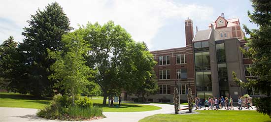 photo of students walking past McMullen Hall on the MSUB university campus
