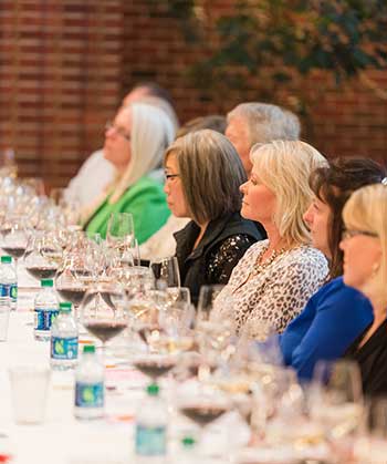 participants listen at a Wine & Food event